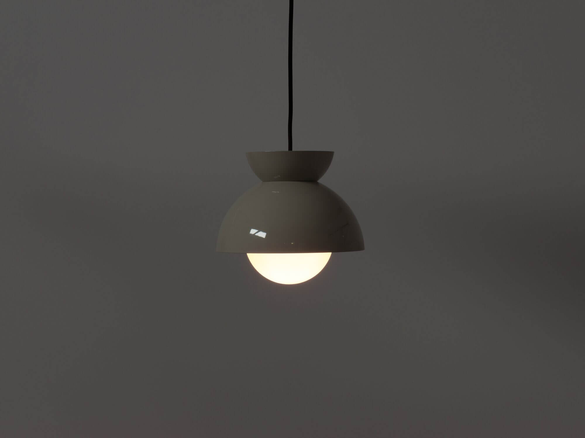 Modern grey pendant lamp with light on side view